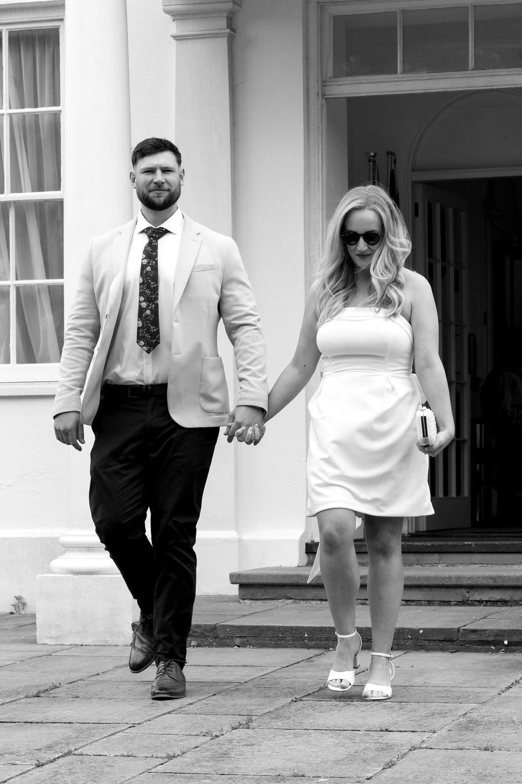 Couple walking hand in hand outside the venue