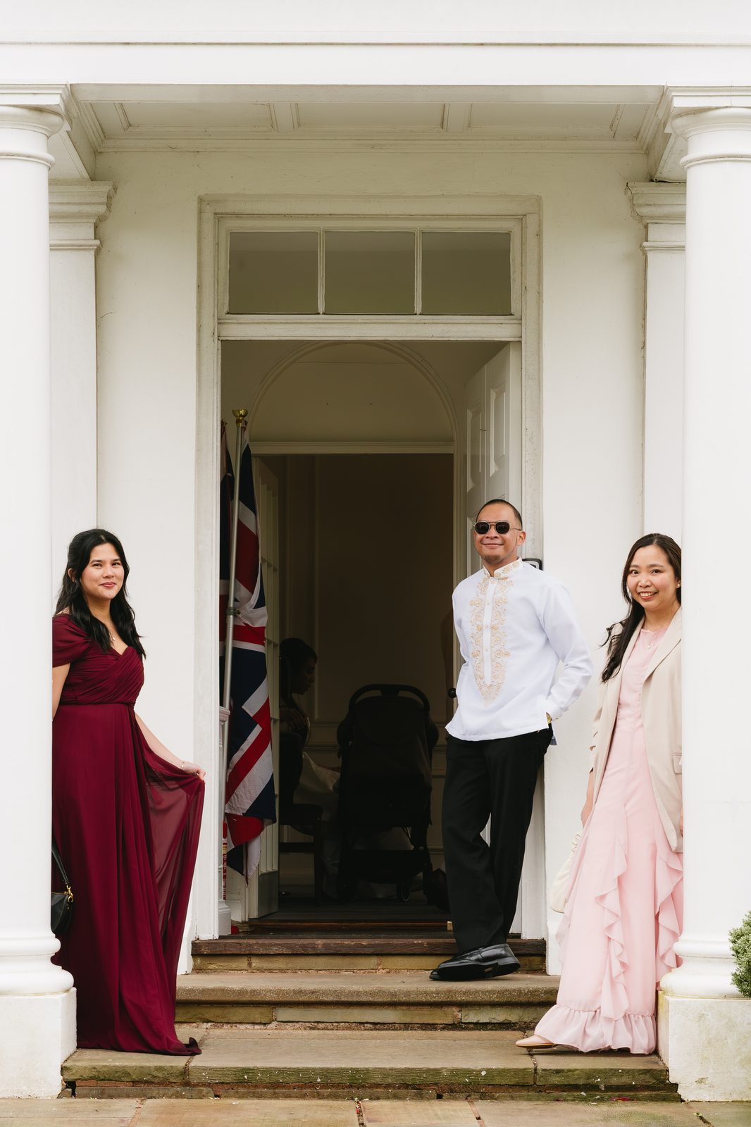 Wedding guests on the steps of the venue